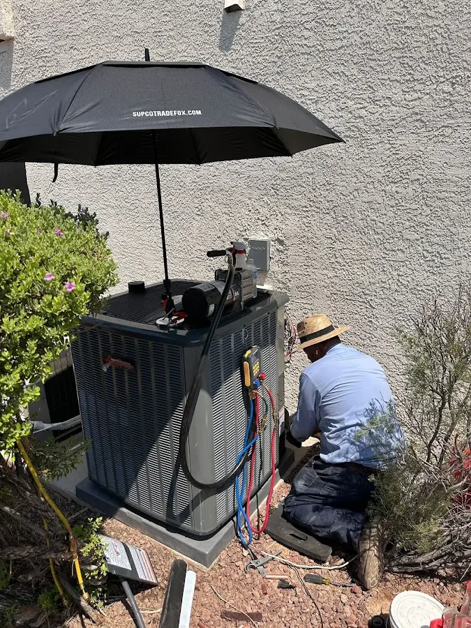 HVAC technician performing outdoor AC maintenance in Mooresville